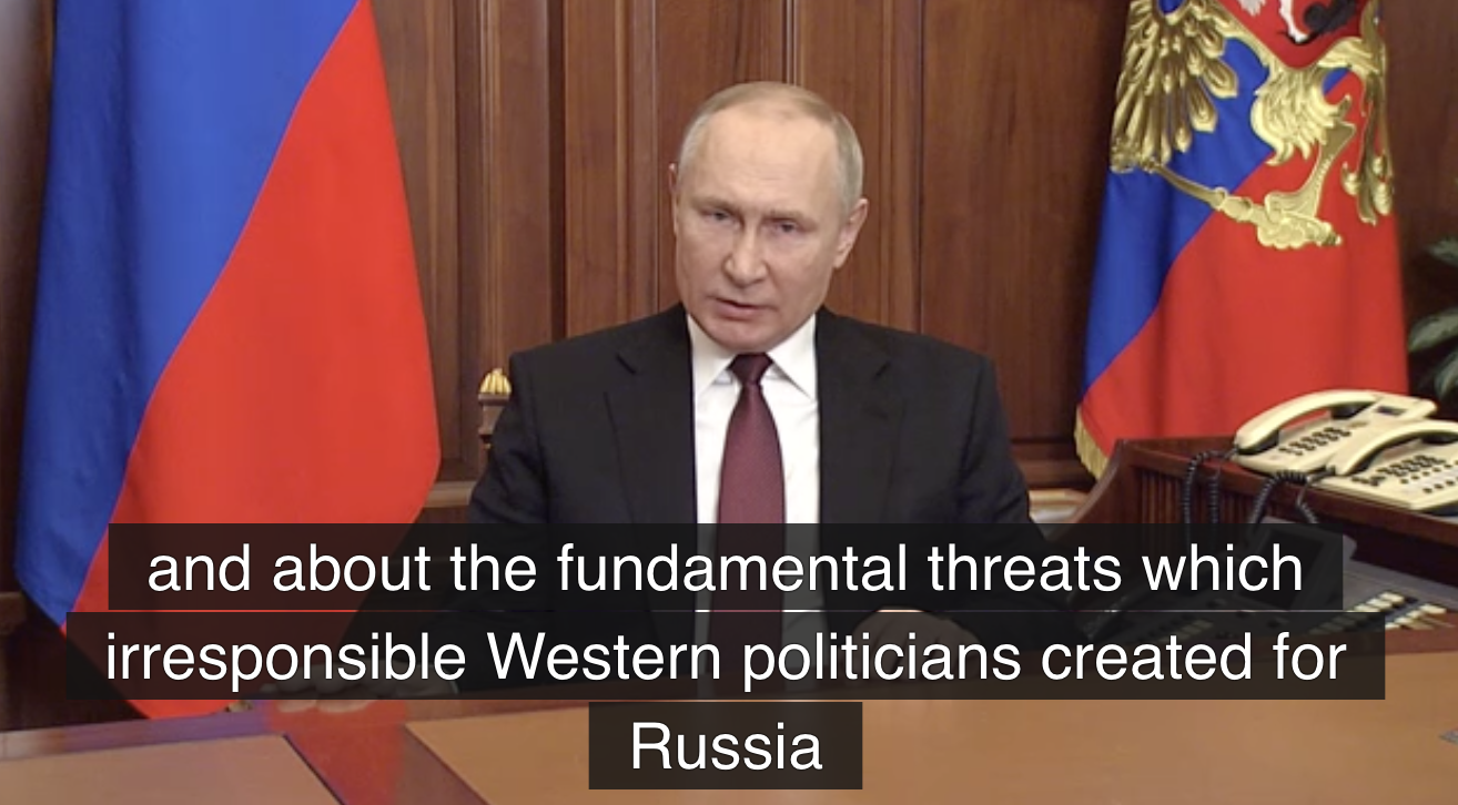 Putin giving a speech at his desk, stating: 